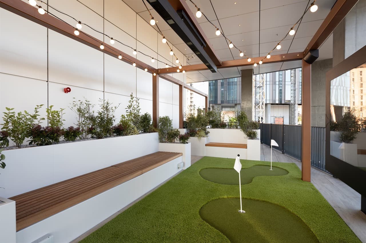 Roof terrace with putting green and festoon lighting at Vista River Gardens, Manchester